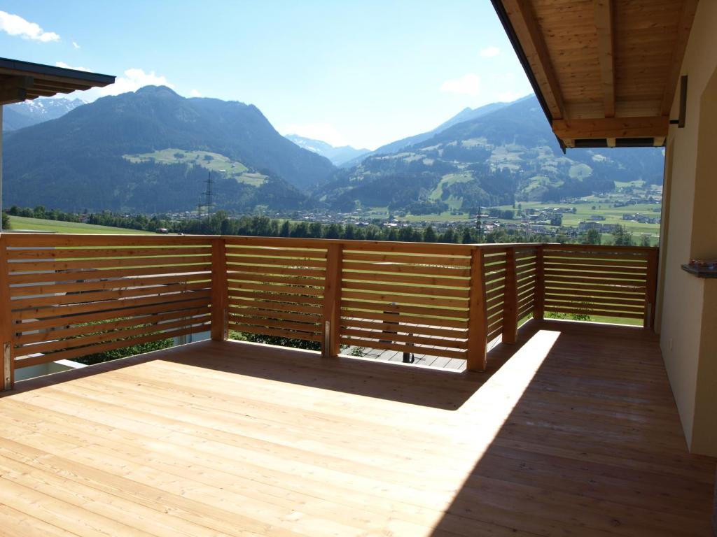 a wooden balcony with a view of mountains at Apartment Lanser in Fügen