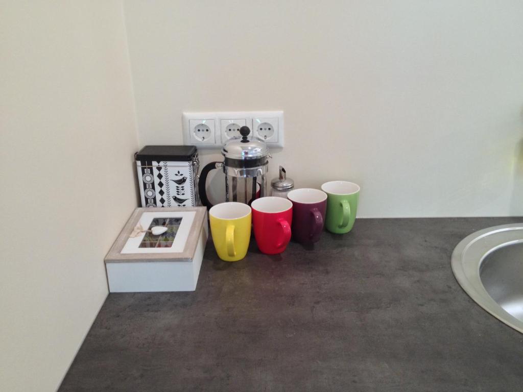 a group of four coffee cups sitting on a counter at Fortuuna 5 Apartment in Tartu