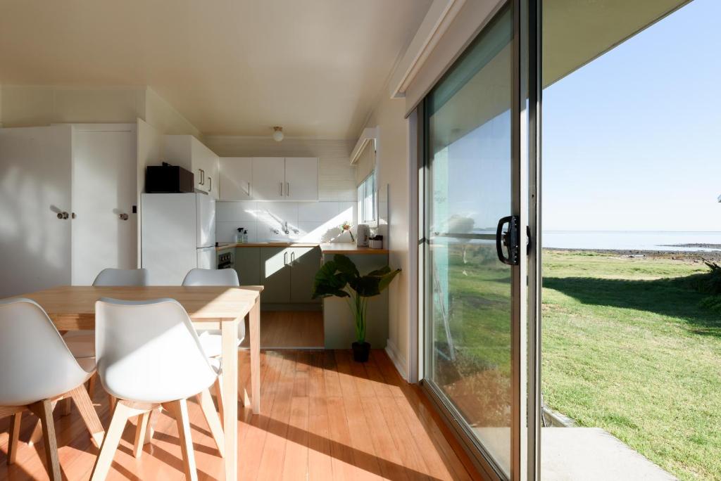a kitchen and dining room with a table and chairs at Simple & Comfortable Coastal Retreat in George Town