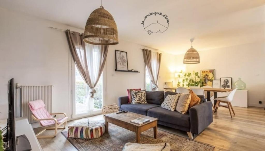 a living room with a couch and a table at La Gergovia #Parking#Terrasse in Romagnat