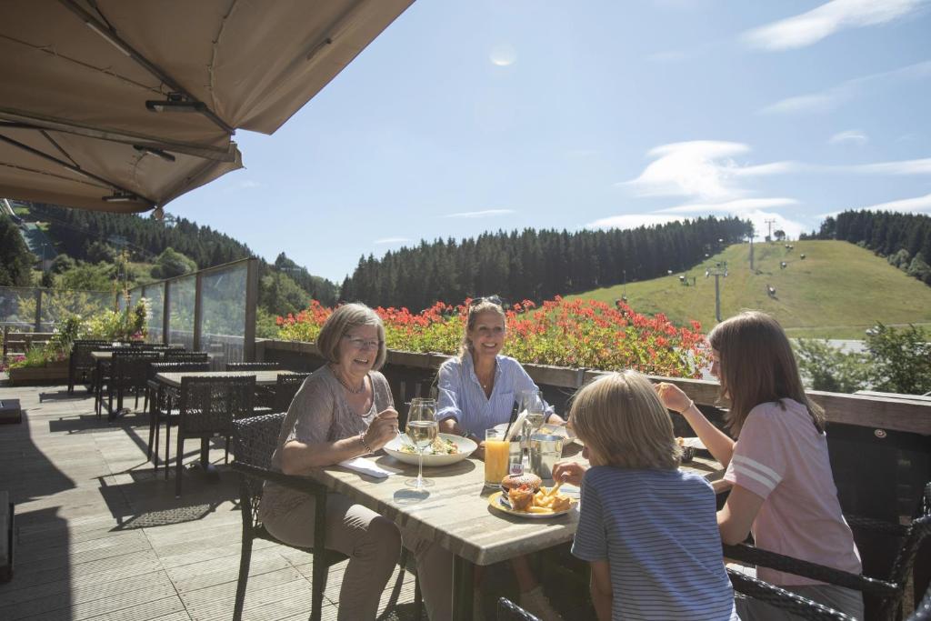 a group of women sitting at a table with food at Landal Winterberg in Winterberg