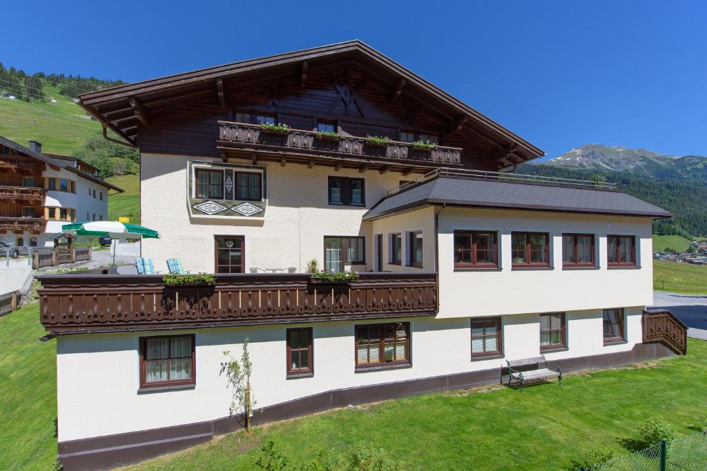 a large white building with a balcony at Haus Morgensonne in Sankt Anton am Arlberg