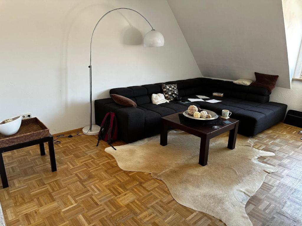 a living room with a black couch and a table at Riverside in Bremen