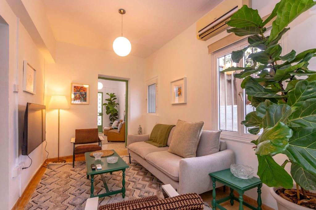 a living room with a couch and a table at Two Bedroom Garden Cottage in Quiet Street in Limassol