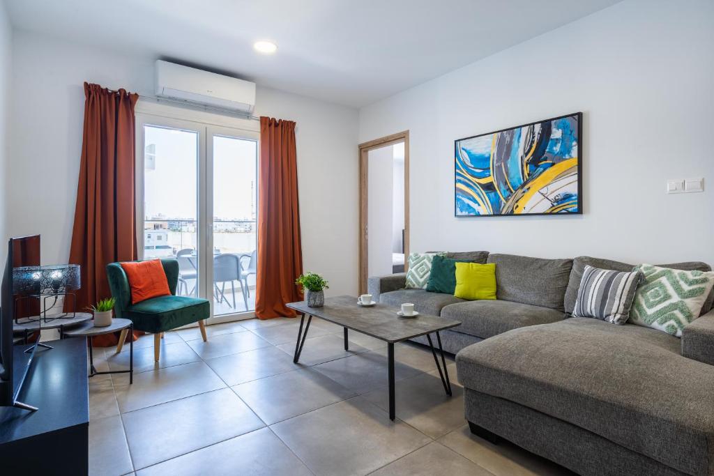 a living room with a couch and a table at Invictus 2-Bedroom Apartment in Larnaca