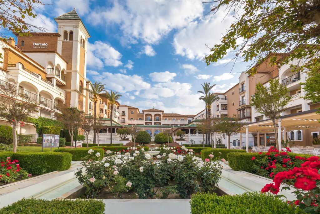 a courtyard with flowers in front of a building at Barceló Isla Canela in Isla Canela