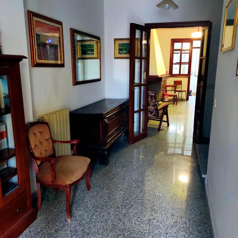a living room with a piano and a chair at i giardini di Ailobran in Narbolia
