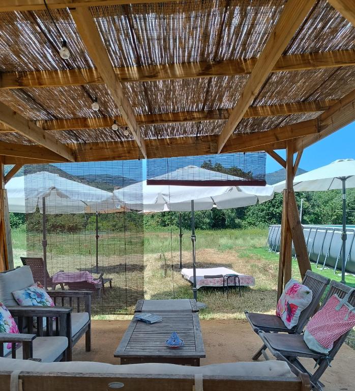 a patio with a table and chairs and an umbrella at Casas Natura Suites Graus in Graus