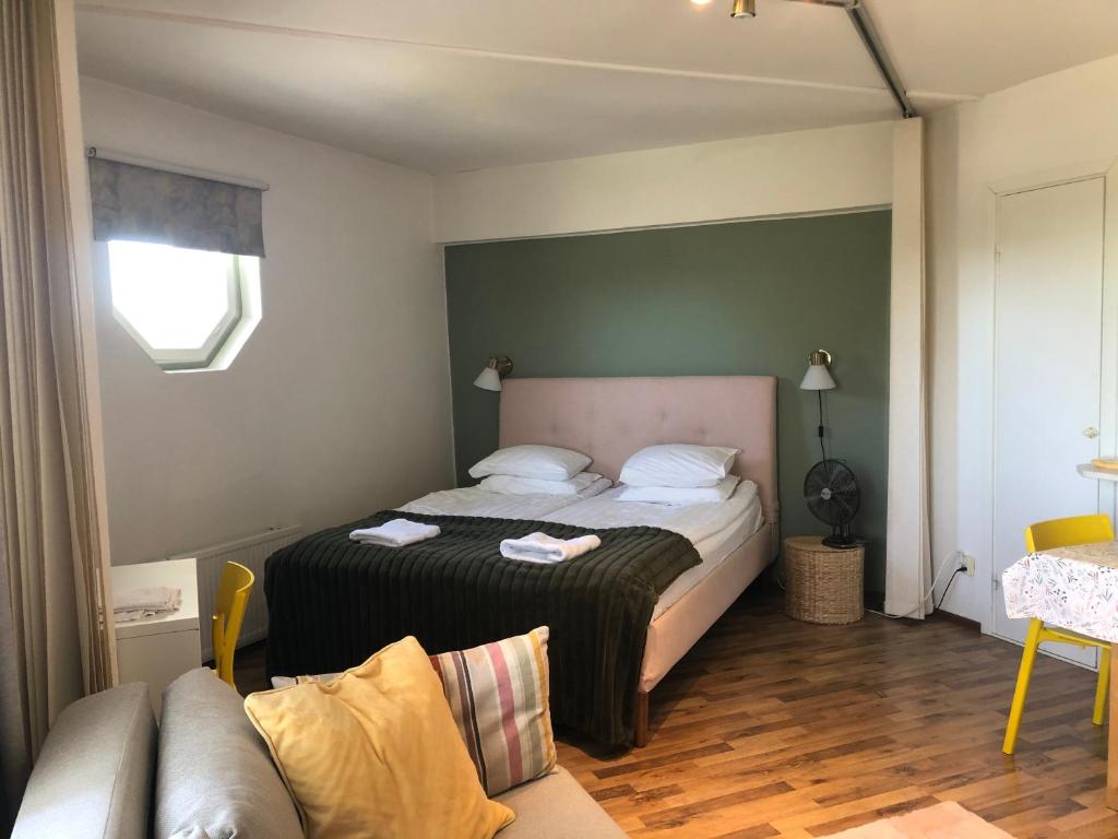 a bedroom with a bed and a couch at Cosy apartment in the city center FREE PARKING in Kemi