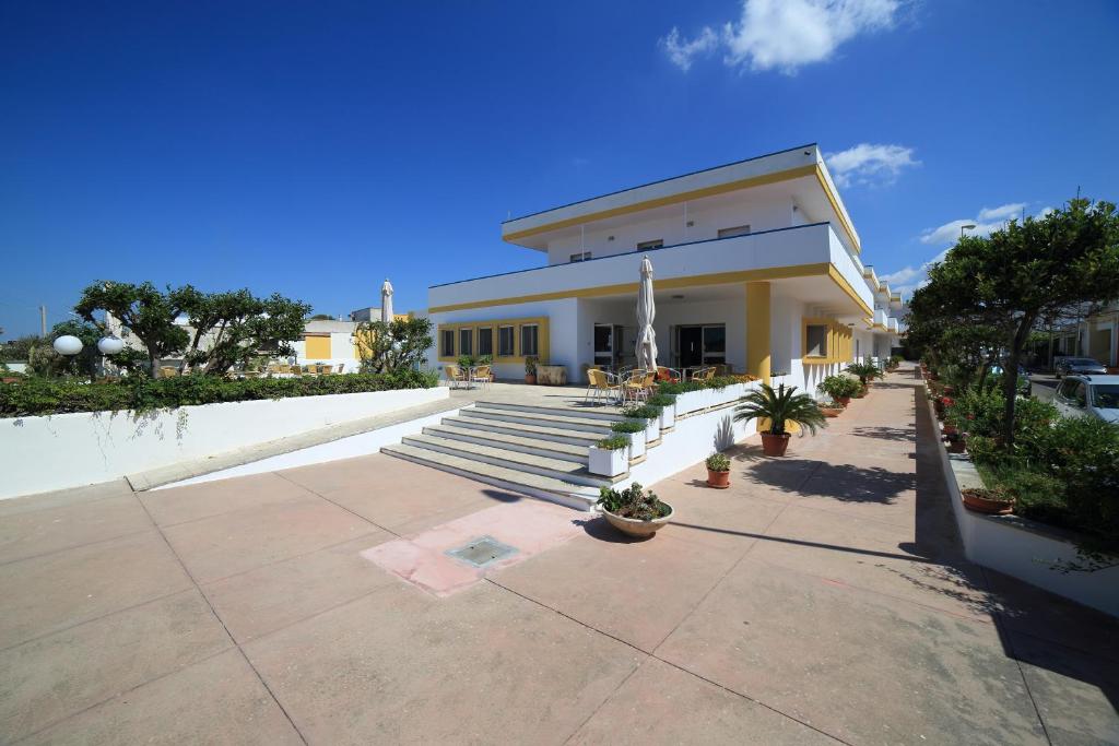 a building with stairs and potted plants in front of it at Hotel Albatros in Torre Vado