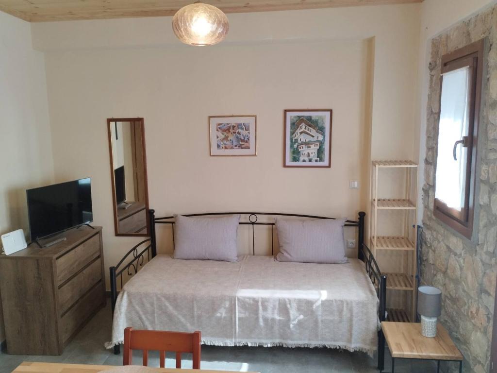 a bedroom with a bed and a television in it at Jenny's House II in Skiathos Town