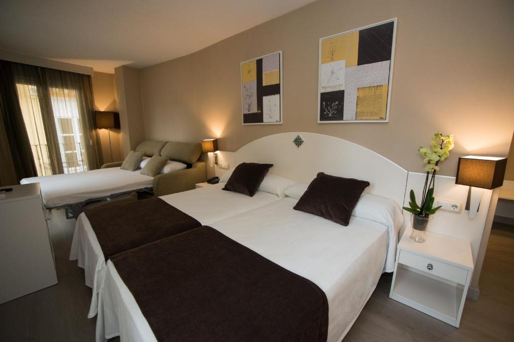 Postel nebo postele na pokoji v ubytování Hotel Torico Plaza