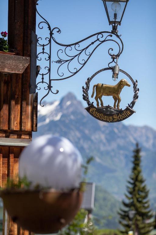 a sign with a horse hanging from a building at Hotel Gasthaus Schäfle in Bürserberg