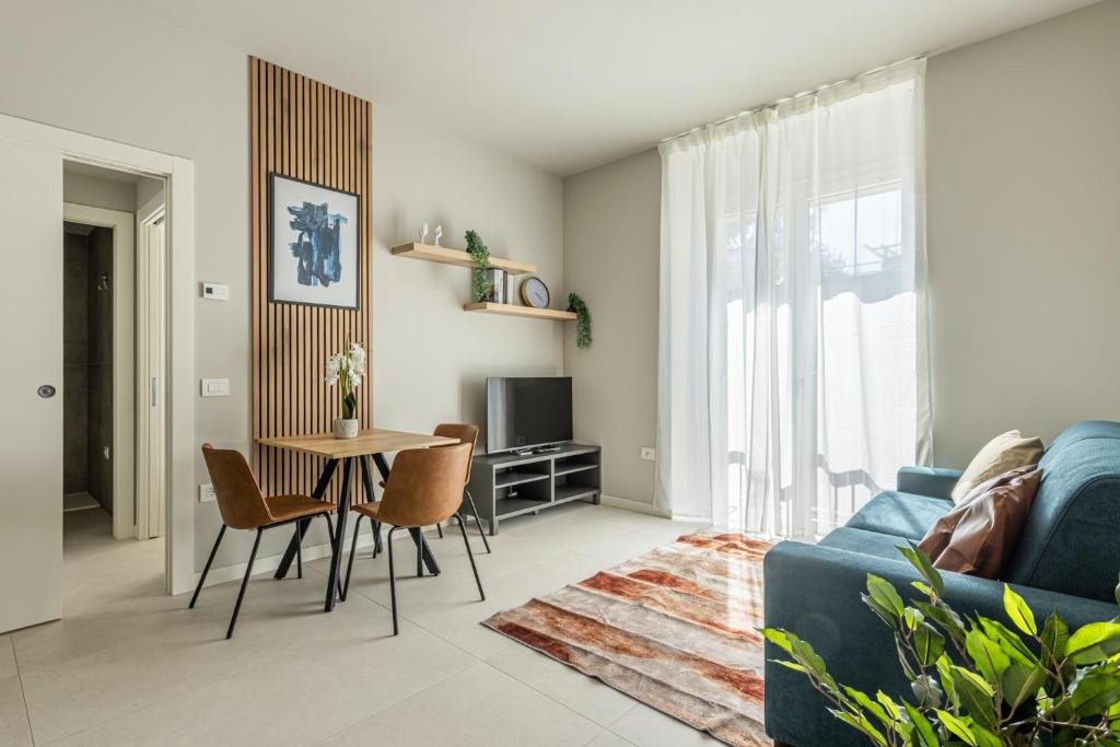 a living room with a blue couch and a table at Binda 21-2F charme moderno Navigli - Vesta in Milan