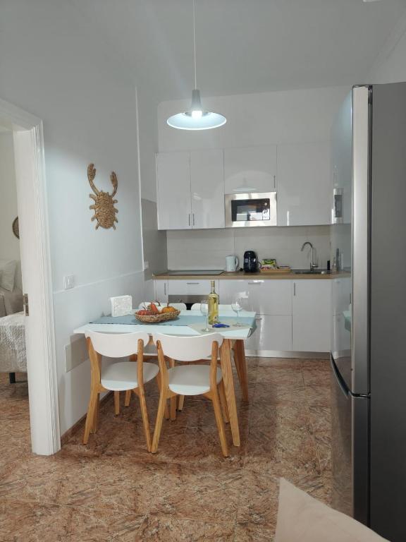 a kitchen with a table and chairs in a room at Maresía La Santa in La Santa