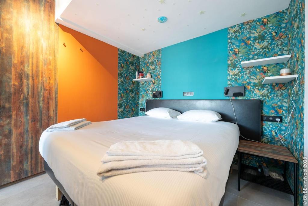 a bedroom with a bed with colorful walls at Ecstatic Living Ixelles, Luxury in the European Quarter in Brussels