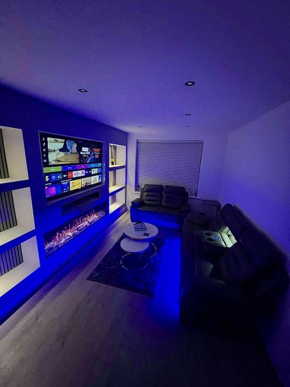 a living room with a couch and a tv at Luxeliving The Larch Residence in High Hazels