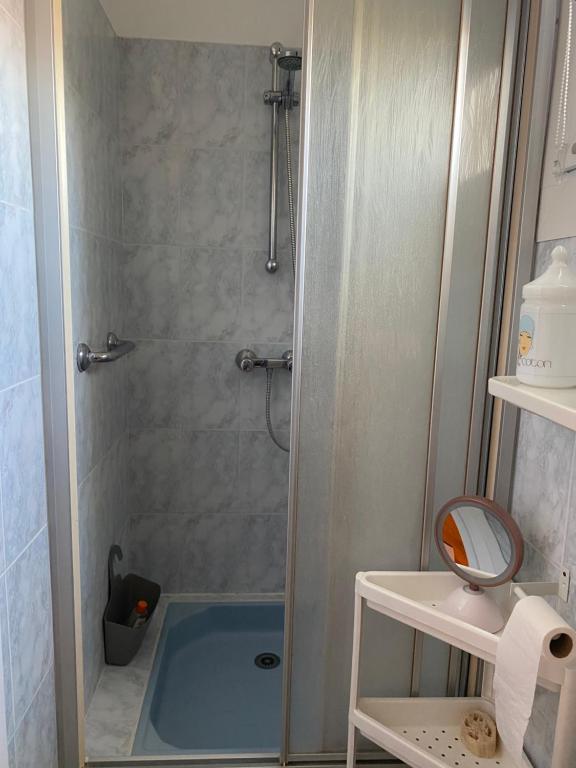 a bathroom with a shower with a blue tub at Villa Saint Georges in Royan