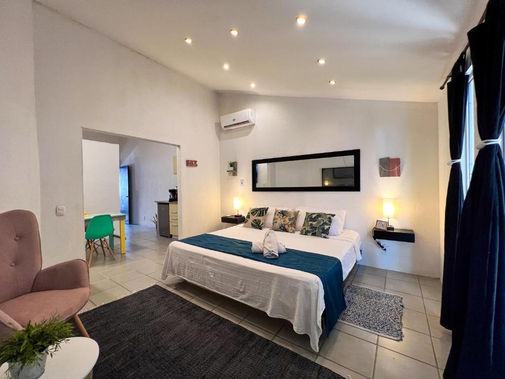a bedroom with a large bed in a room at Ocean Lovers Taganga - PADI Dive Center & Hostel in Taganga
