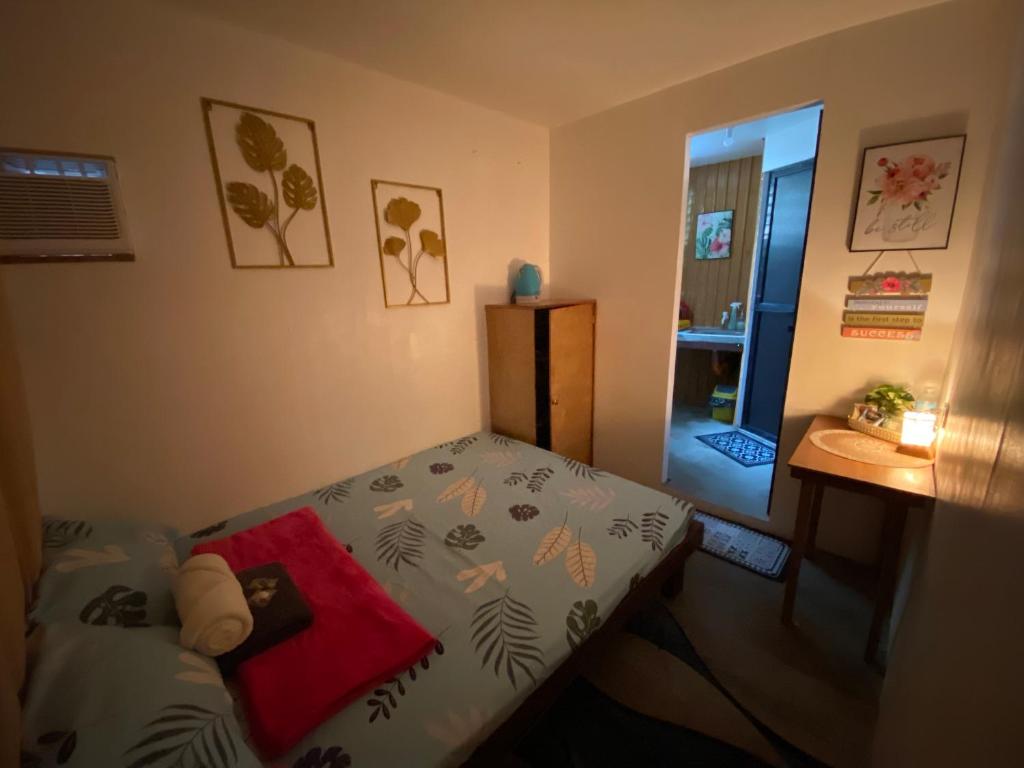 a bedroom with a bed and a table and a door at WIldFlower in General Luna