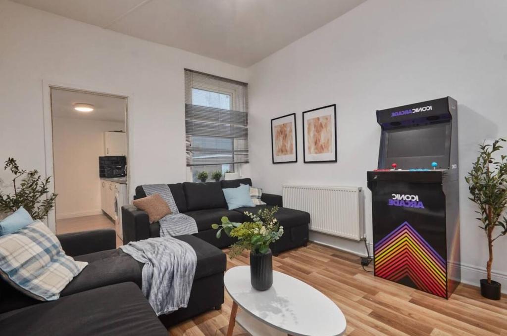 a living room with a video game in a living room at 4 bedroom, 6 beds, 10 guest, Free parking on site in Elswick