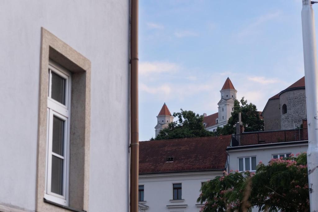 a white building with two towers in the background at Room with 2 beds in the Old Town in Bratislava