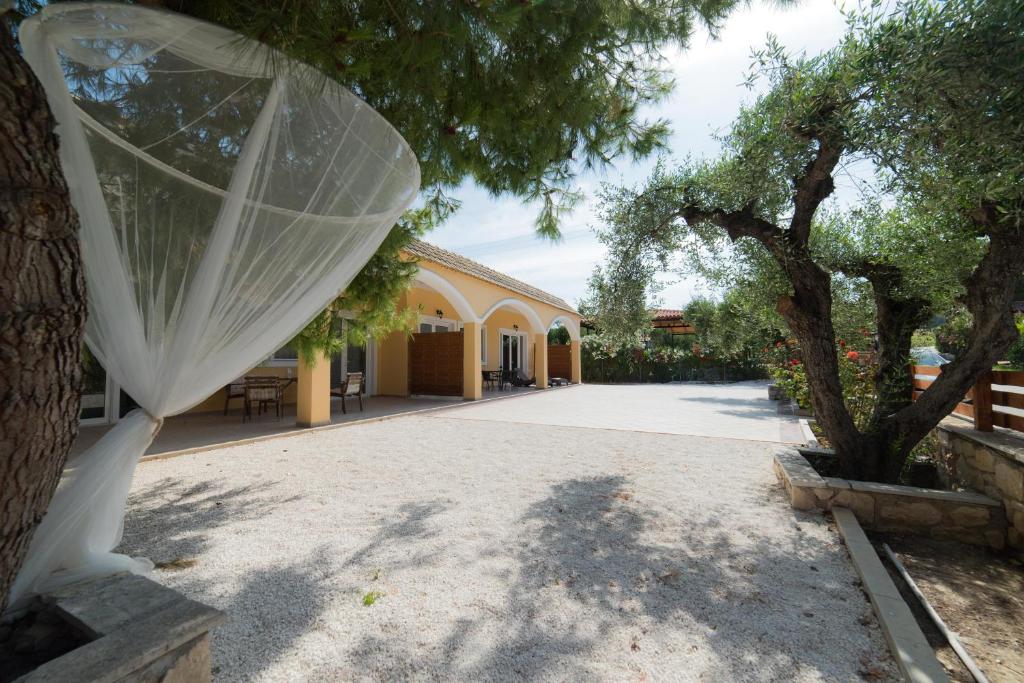a wedding veil is tied to a tree in a driveway at Casa Di Porto Roma in Vasilikos