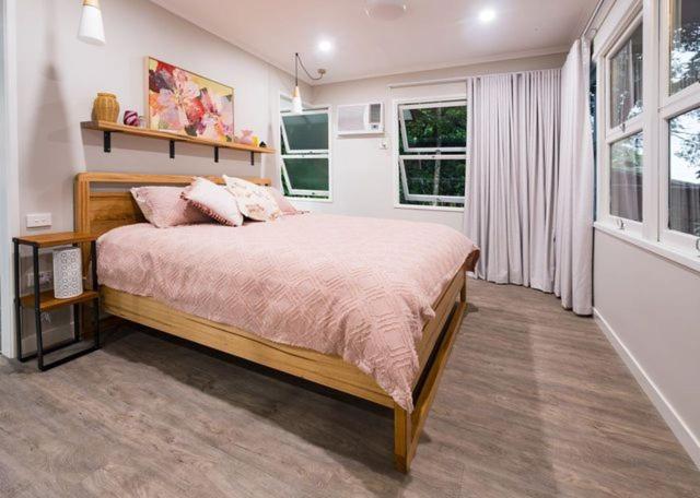 a bedroom with a large bed and a window at The Point in Innisfail