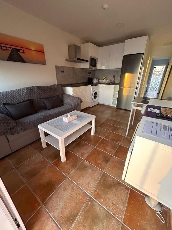 a living room with a couch and a table at Granada I Apartment- Patalavaca in Patalavaca