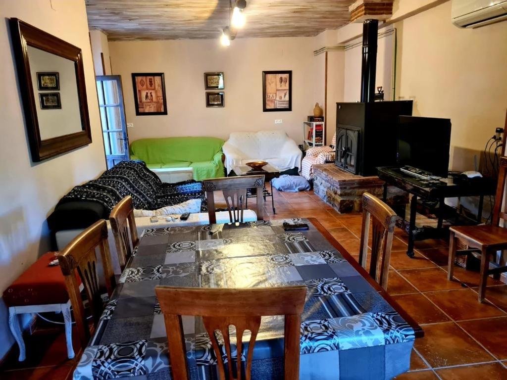 a living room with a table and a green couch at Torreon de Nubla in Cazorla