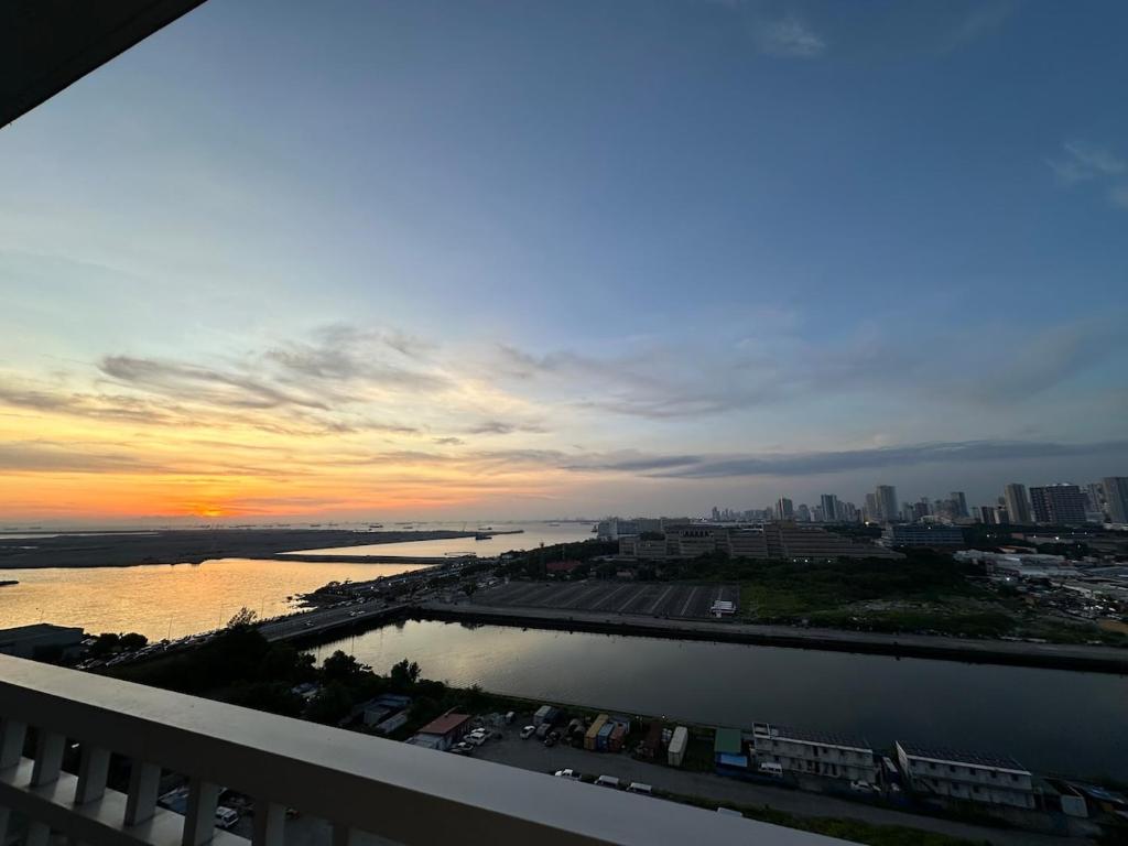 a view of a sunset from the balcony of a building at Seaside Manila Bay Sunset View at SM Mall of Asia in Manila