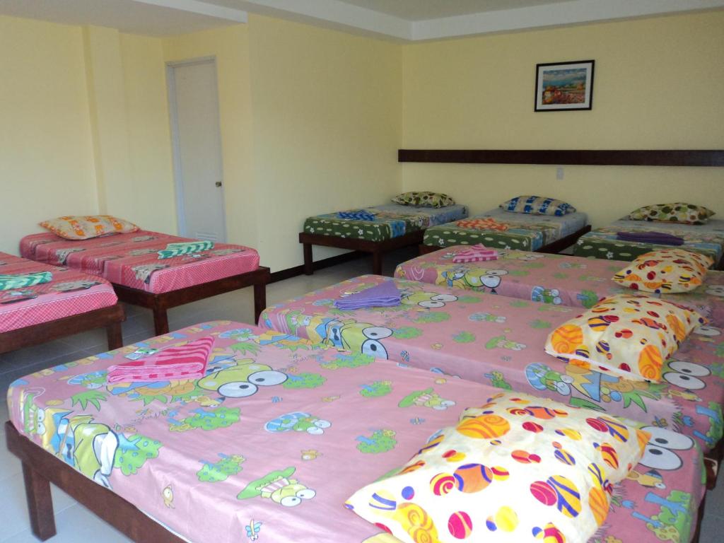 Postel nebo postele na pokoji v ubytování Greenfields Tourist Inn