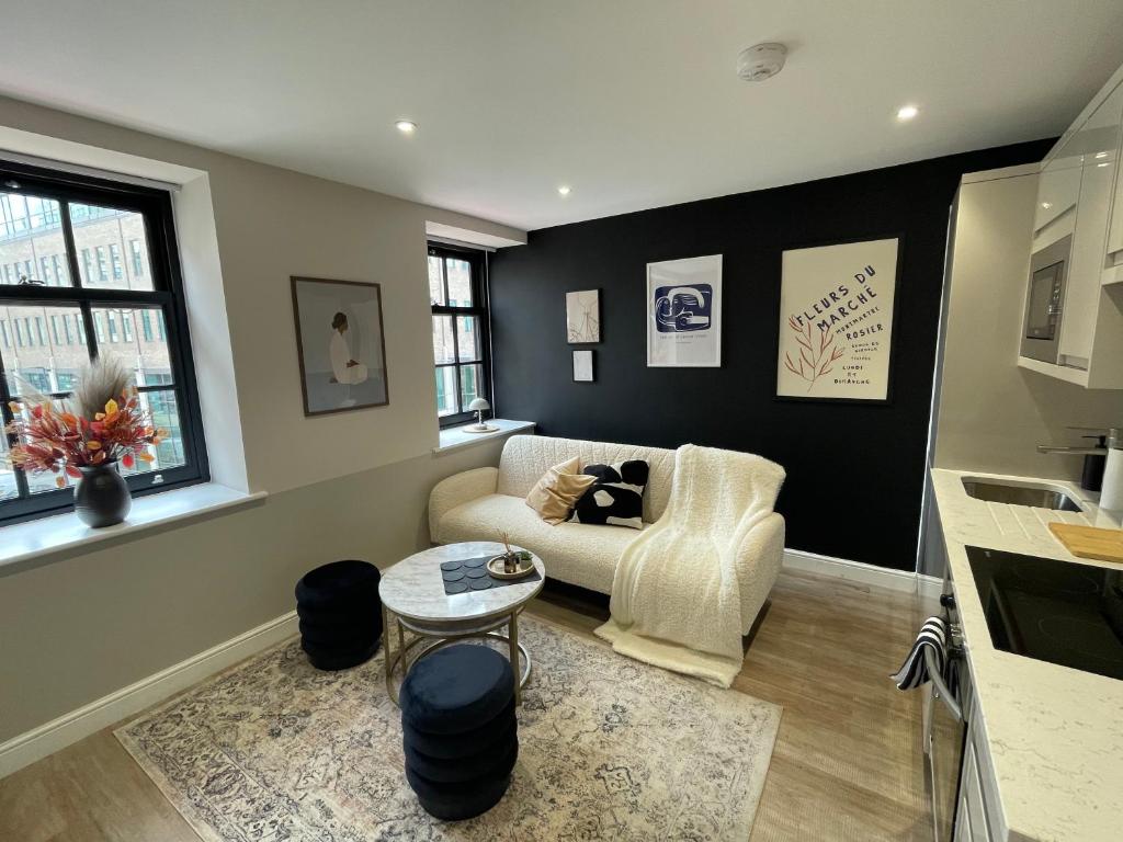 a living room with a couch and a table at Chic central Leeds retreat in Central Station