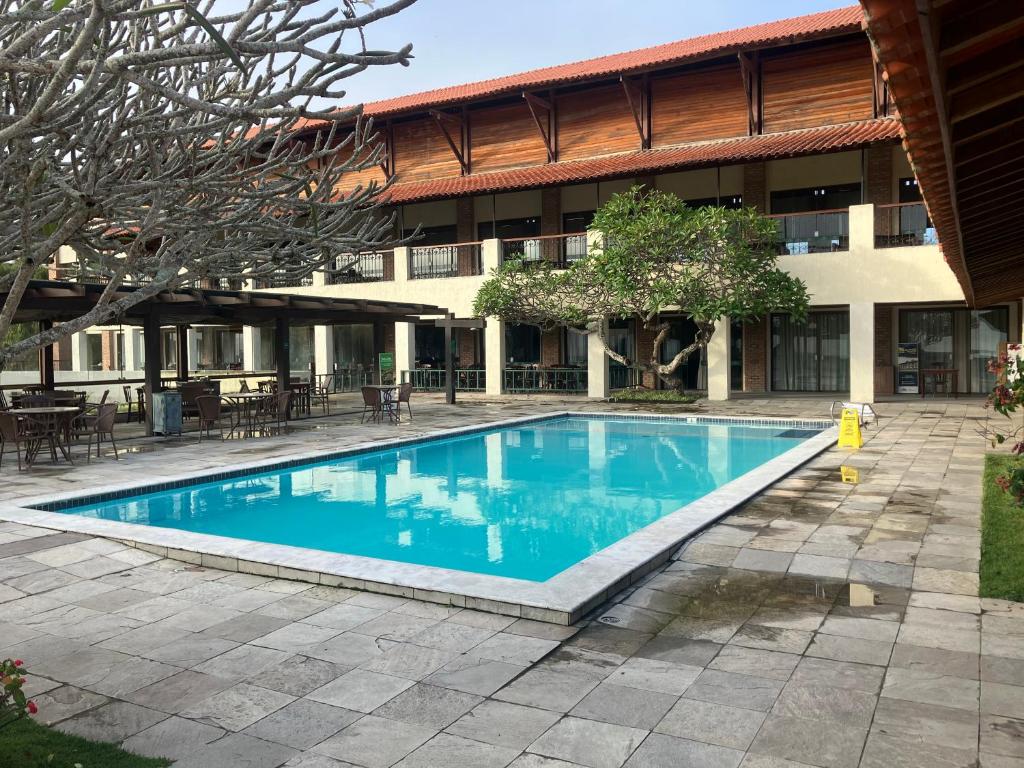 a swimming pool in front of a building at Flat 3 Mobiliado no Condominio Flats Monte Castelo - Gravatá PE in Bezerros