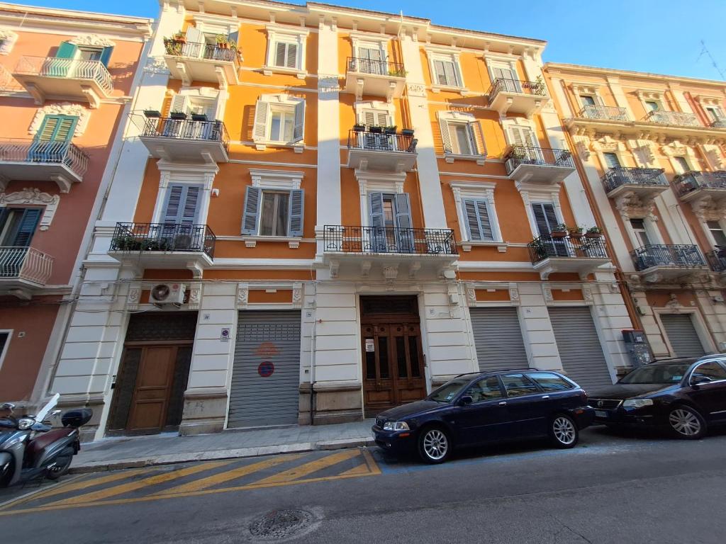 バーリにあるDimora turistica via Tanzi 27 Bariの建物の前に駐車した車両2台