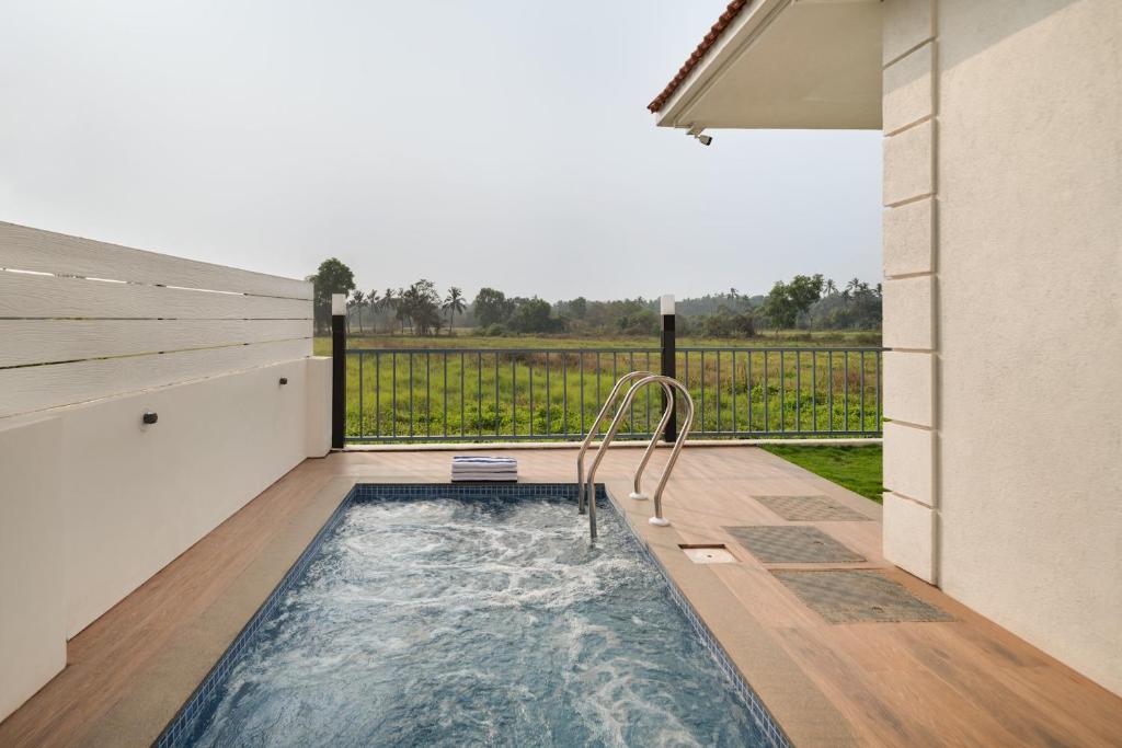 a hot tub in the backyard of a house at Greenfield · 3BHK Portuguese Villa in Assagao Goa in Goa
