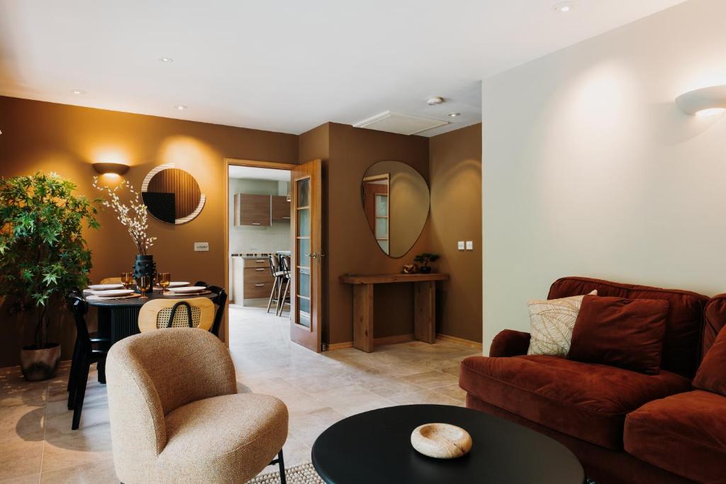 a living room with a couch and a table at Shizuka Lodge - Award-Winning Gardens near Ventnor in Ventnor