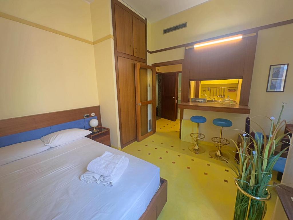 a bedroom with a white bed and a kitchen at Appartme Nuova 52 in Milan