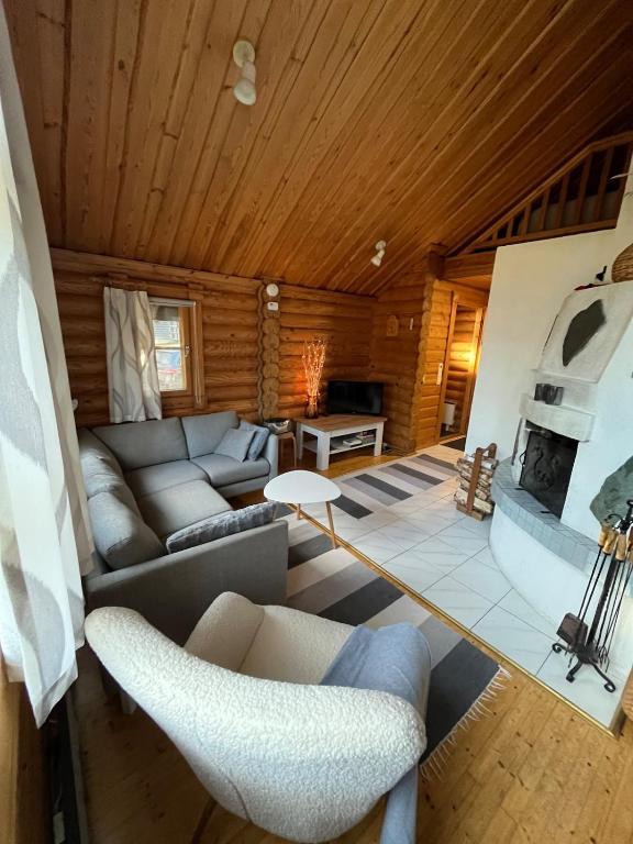 a living room with a couch and a fireplace at HonkaRuka, Agrohonka in Ruka