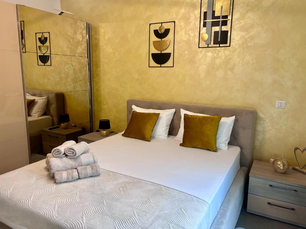 a bedroom with a bed with a towel on it at Biby Luxury Apartament in Ploieşti