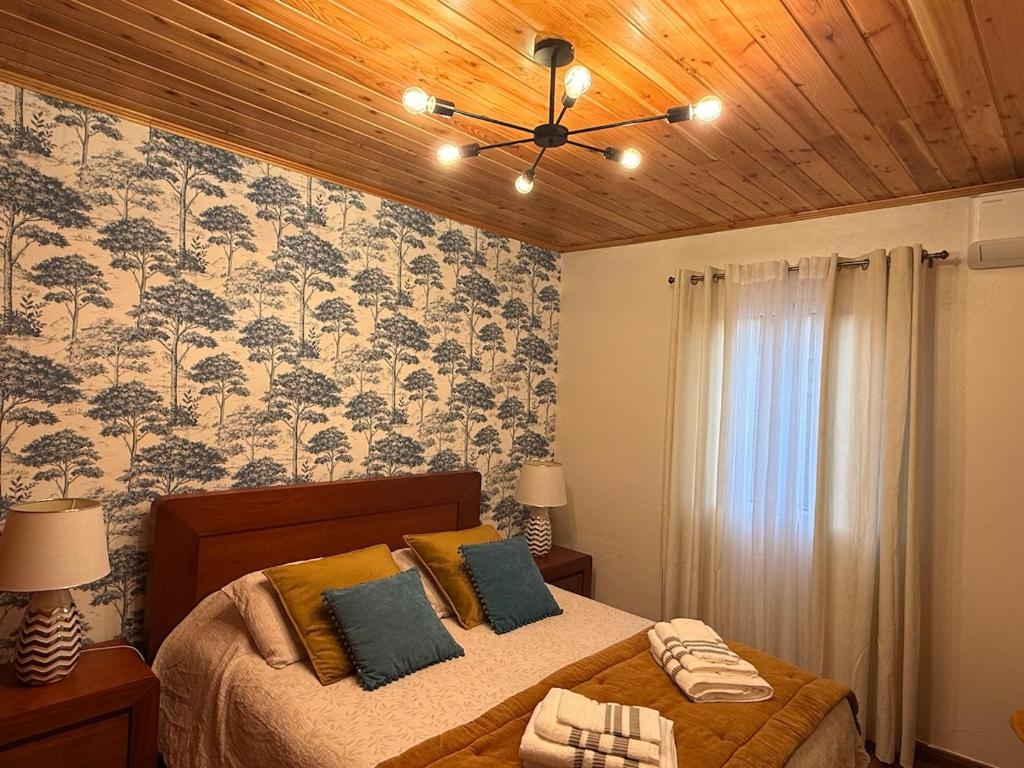 a bedroom with a bed with a ceiling fan at Family Home - Alojamento Local in Nordeste