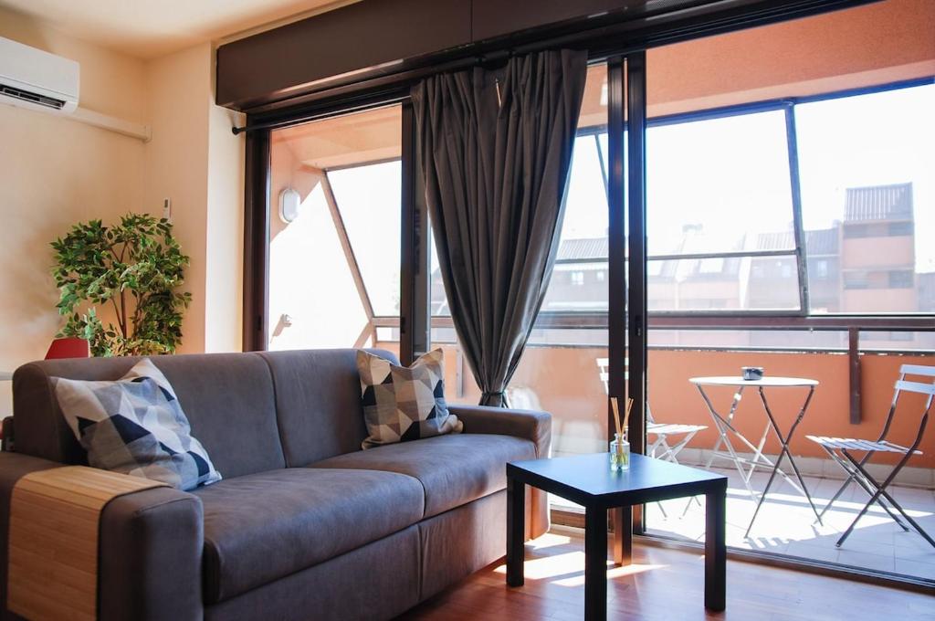 a living room with a couch and a table at Home & Pet - Tralci in Basiglio