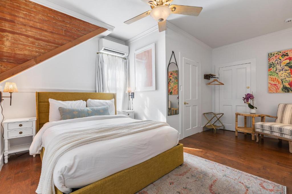 a bedroom with a large bed and a ceiling fan at THE WHITEHEAD ROOM at Inn on Fleming Key West! in Key West