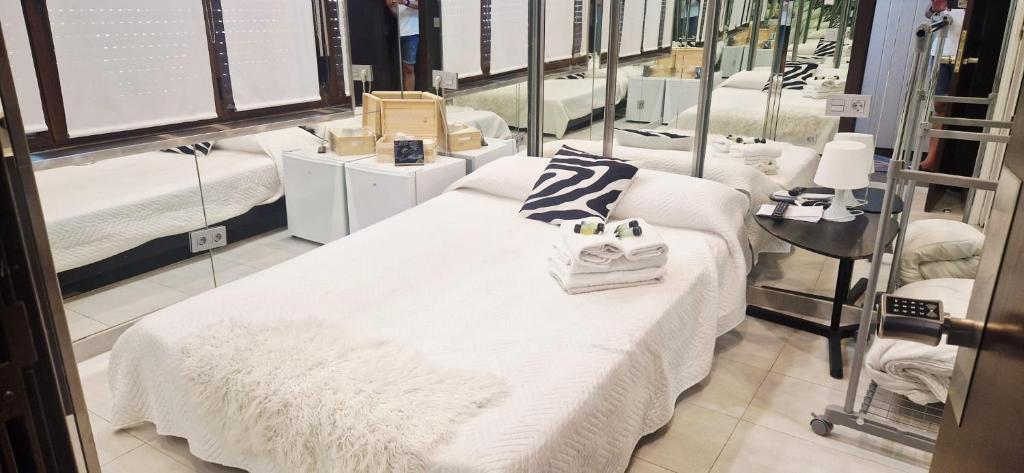 a room with several beds in a store at Hostal del Currante Babilafuente in Babilafuente