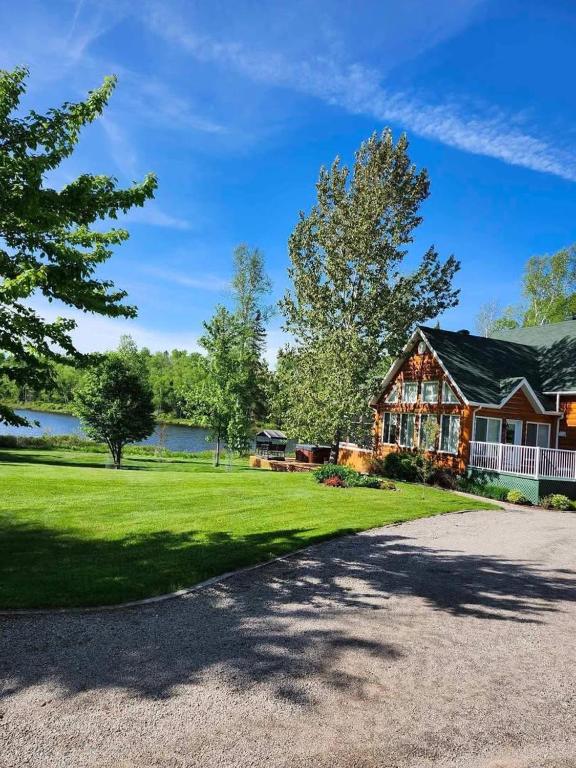 a large house with a driveway in front at Le Grand Boisé in Saint Zenon