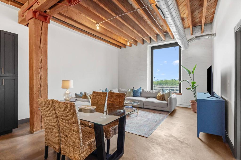 a living room with a table and chairs at Brick & Bed, Riverfront Lofts, P 4J in Saint Louis