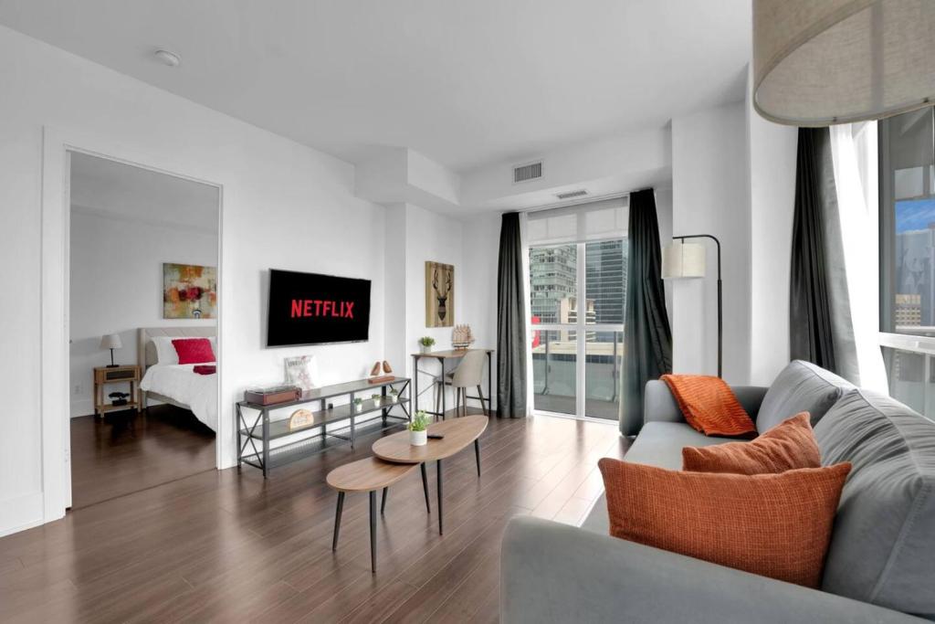 a living room with a couch and a table at Lakeview Unit - sleeps 11 people near CN Tower Union Rogers Centre and Convention Centre in Toronto