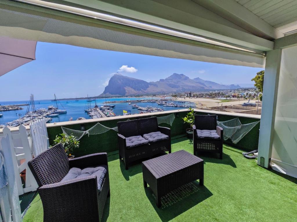 a balcony with chairs and a view of a harbor at Il Torrazzo da Francesca in San Vito lo Capo