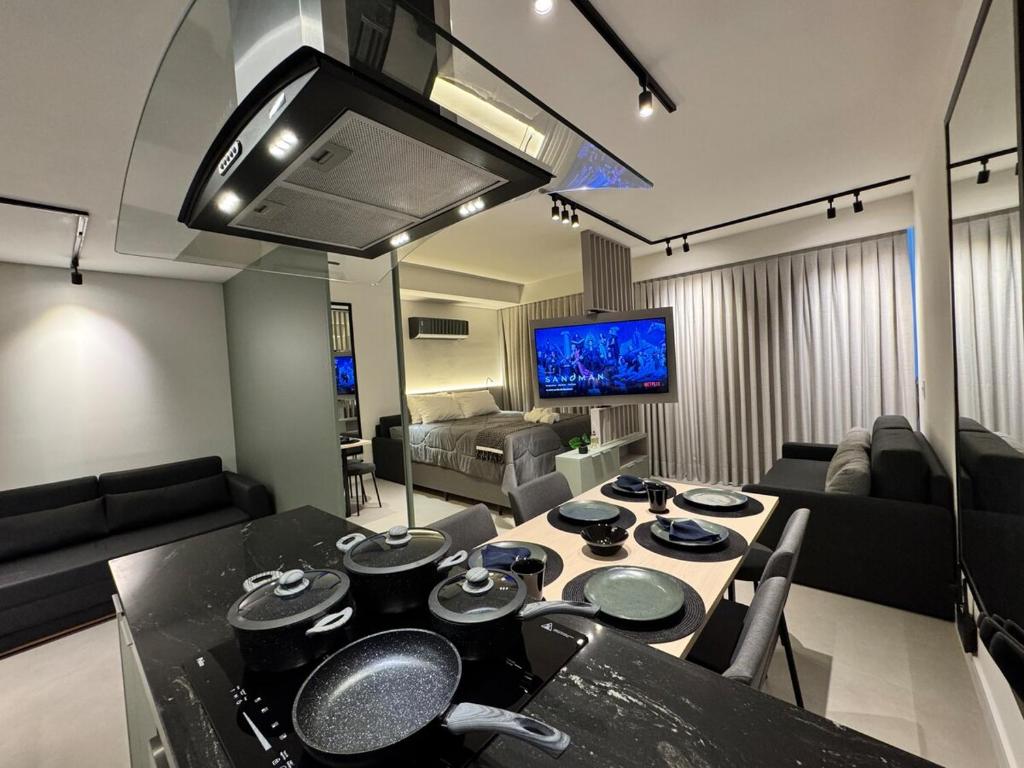 a kitchen and living room with a table and a couch at Studio b2b in Florianópolis