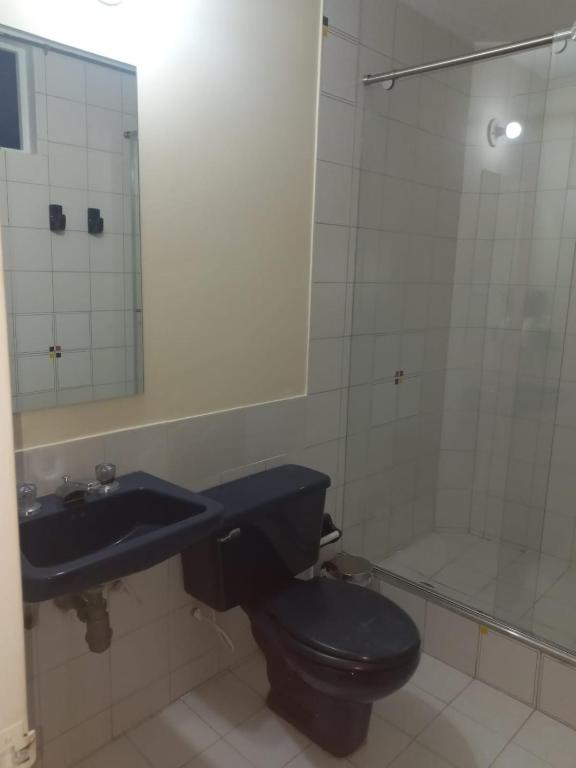 a bathroom with a toilet and a sink and a shower at centro bogota in Bogotá